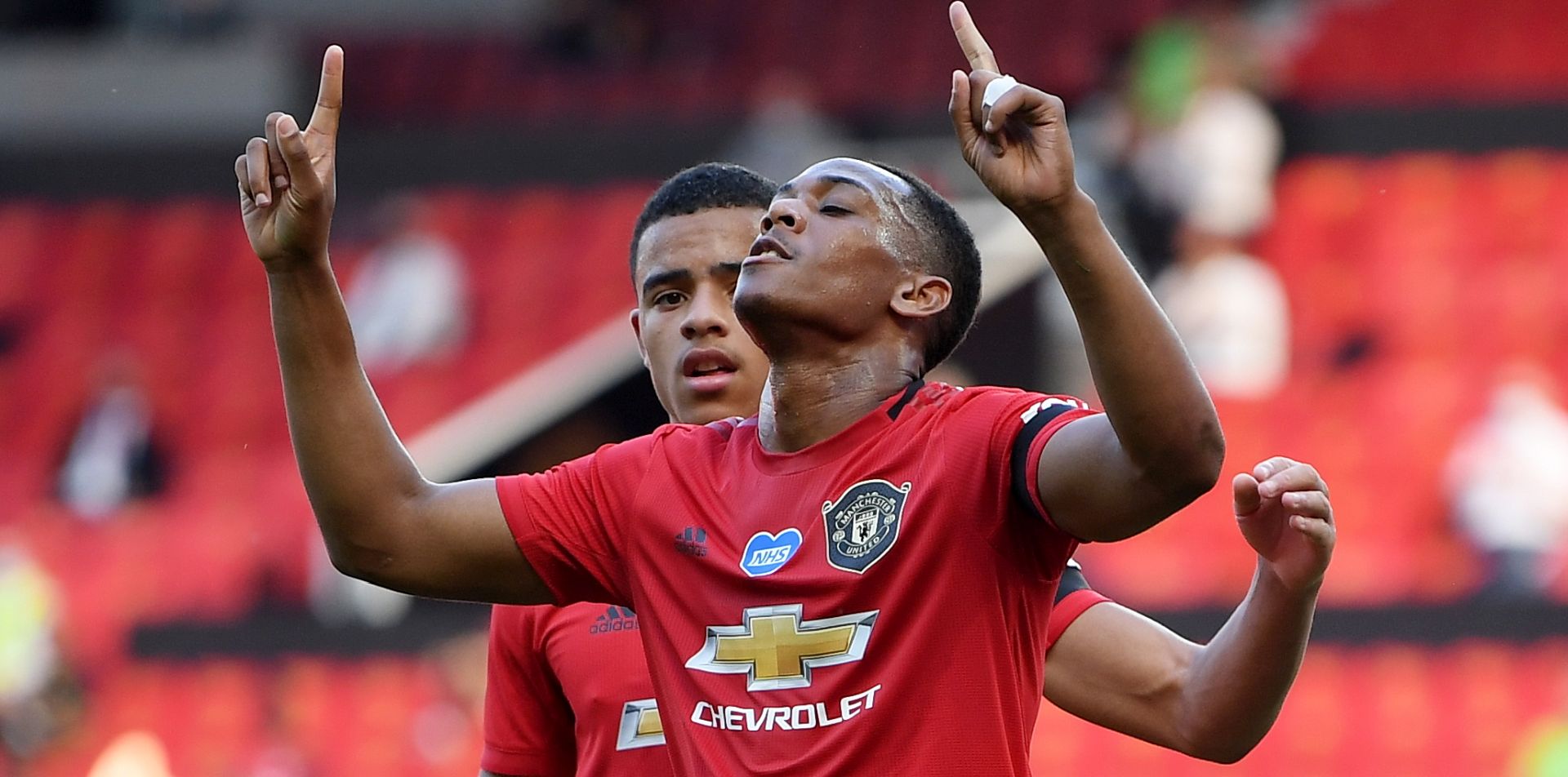 epa08506561 Anthony Martial (R) of Manchester United celebrates with teammate Mason Greenwood after scoring the 2-0 during the English Premier League match between Manchester United and Sheffield United in Manchester, Britain, 24 June 2020.  EPA/Michael Regan/NMC/Pool EDITORIAL USE ONLY. No use with unauthorized audio, video, data, fixture lists, club/league logos or 'live' services. Online in-match use limited to 120 images, no video emulation. No use in betting, games or single club/league/player publications.