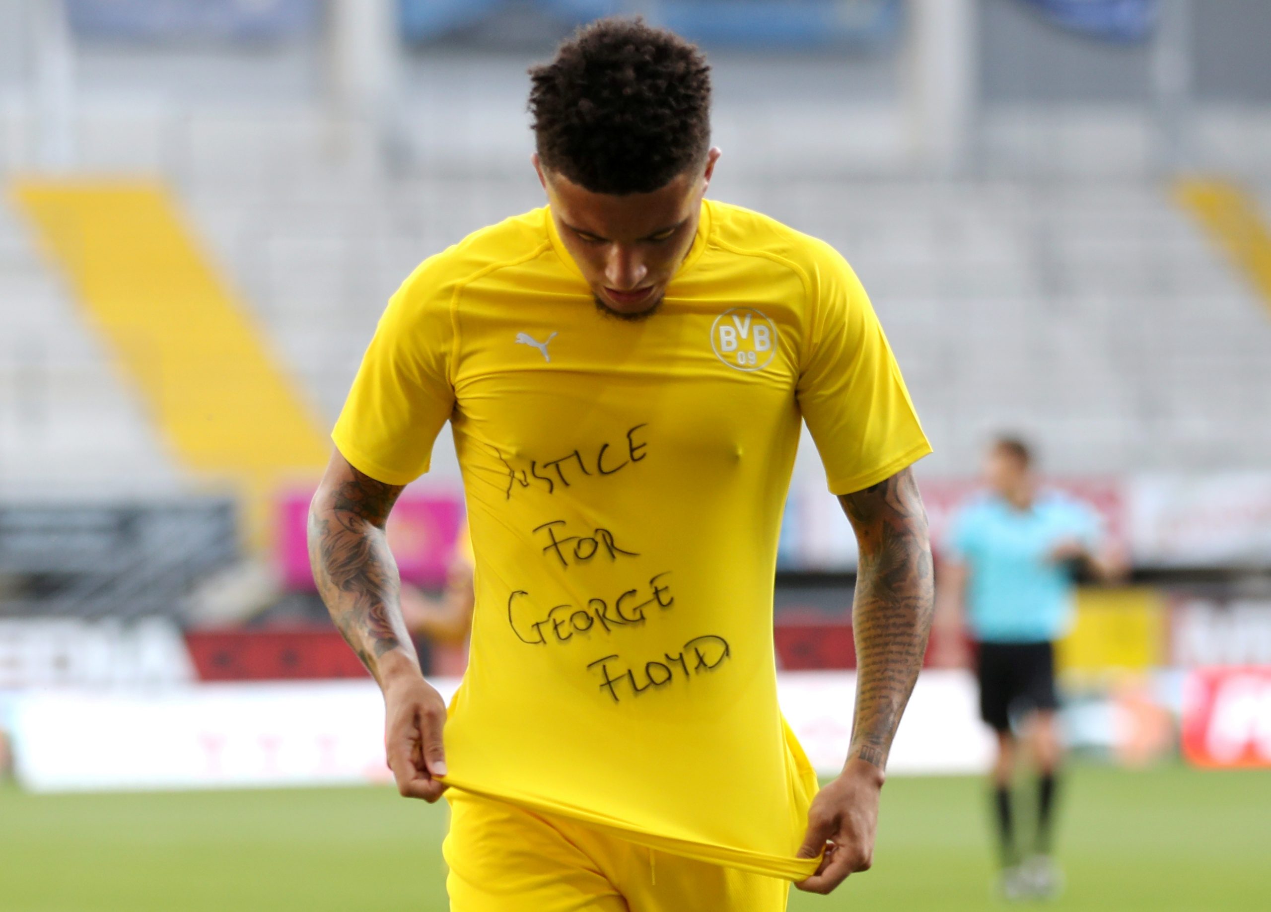 Bundesliga - SC Paderborn v Borussia Dortmund Soccer Football - Bundesliga - SC Paderborn v Borussia Dortmund - Benteler Arena, Paderborn, Germany - May 31, 2020 Borussia Dortmund's Jadon Sancho celebrates scoring their second goal with a 'Justice for George Floyd' shirt, as play resumes behind closed doors following the outbreak of the coronavirus disease (COVID-19) Lars Baron/Pool via REUTERS   DFL regulations prohibit any use of photographs as image sequences and/or quasi-video     TPX IMAGES OF THE DAY POOL
