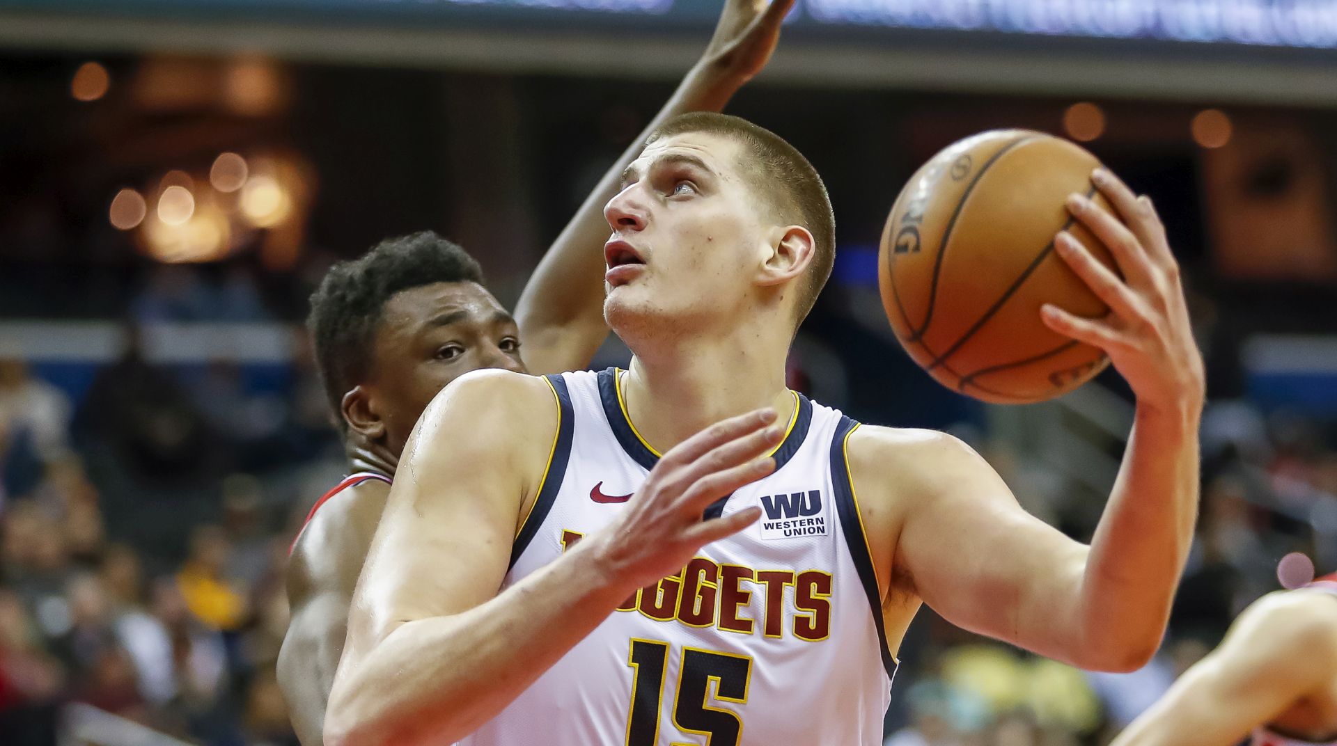 epa08505950 (FILE) - Denver Nuggets center Nikola Jokic (R) in action against Washington Wizards center Thomas Bryant (L) during the NBA basketball game between the Denver Nuggets and the Washington Wizards in Washington, DC, USA, 21 March 2019 (re-issued on 24 June 2020). Serbian basketball player Nikola Jokic of the Denver Nuggets was tested positive for the coronavirus COVID-19 disease, the Denver Post confirmed on late 23 June 2020. Jokic met Serbian tennis player Novak Djokovic during the Adria Tour tennis tournament in Belgrade.  EPA/ERIK S. LESSER SHUTTERSTOCK OUT