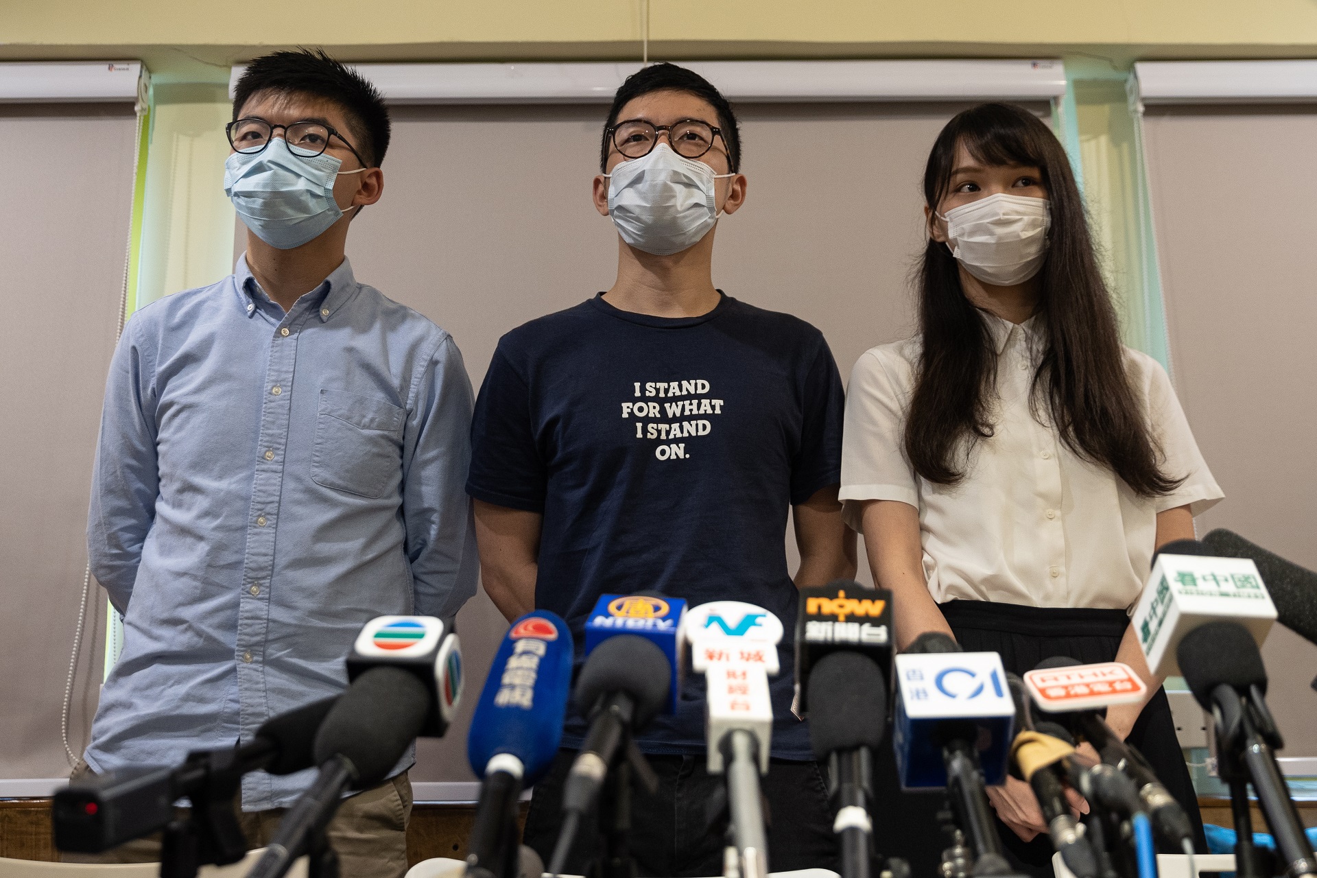 epa08516928 (FILE) - Members of the pro-democracy political group Demosisto, Joshua Wong (L), Nathan Law (C) and Agnes Chow (R) speak during a press conference in Hong Kong, China, 30 May 2020 (reissued 30 June 2020). The three members of Demosisto on 30 June announced quitting the Hong Kong pro-democracy group shortly after media reported that China had passed the controversial national security law.  EPA/JEROME FAVRE