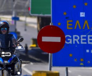 epa08520652 A man rides his motorcycle in front of an EU sign at the entrance to Greece at the border crossing 'Evzoni' between North Macedonia and Greece, near the southern city of Gevgelija, North Macedonia, 01 July. Greece reopened the Evzoni border crossing with North Macedonia to EU citizens and from 14 other countries which are on a list approved by EU authorities. All travelers arriving to Greece are required to fill a Passenger Locator Form (PLF) at least 48 hours before check-in. The form is part of the country's planning for protection against the coronavirus disease (COVID-19) pandemic and will allow authorities to create barcodes for travelers so that testing of new arrivals can be targeted.  EPA/GEORGI LICOVSKI