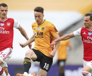 epa08527278 Diogo Jota (C) of Wolverhampton in action against Granit Xhaka (L) and Cedric Soares (R) of Arsenal during the English Premier League match between Wolverhampton Wanderers and Arsenal London in Wolverhampton, Britain, 04 July 2020.  EPA/Cath Ivill/NMC/Pool EDITORIAL USE ONLY. No use with unauthorized audio, video, data, fixture lists, club/league logos or 'live' services. Online in-match use limited to 120 images, no video emulation. No use in betting, games or single club/league/player publications.