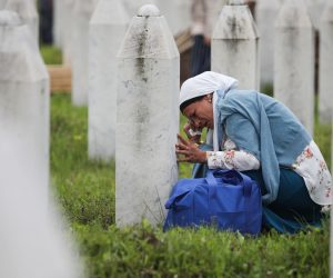 epa08529982 (FILE) - A mourning woman sits between gravestones on the Potocari Memorial Center in Srebrenica, Bosnia and Herzegovina, 11 July 2018 (reissued 06 July 2020). A group of 35 victims of the war crime massacre were transferred from the  town of Visoko to be buried on the city's Potocari Memorial Center on the occasion of the 23rd anniversary of the massacre. A quarter of a century ago, the world witnessed the worst mass murder on European soil since World War II. Some 7,000-8,000 Bosniaks were slaughtered and 20,000 civilians were forcibly displaced in an act of ethnic cleansing perpetrated in the small eastern Bosnian village of Srebrenica, whose name will forever be linked to the infamous 1995 massacre. Today, 25 years after the massacre, the memory of its victims is kept alive by several institutions, such as the Museum of Crimes Against Humanity and Genocide in Sarajevo or a permanent exhibit at the 'Memorial Center Srebrenica-Potocari' that now occupies the former headquarters of the Dutch UNPROFOR Battalion.  EPA/JASMIN BRUTUS  ATTENTION: This Image is part of a PHOTO SET