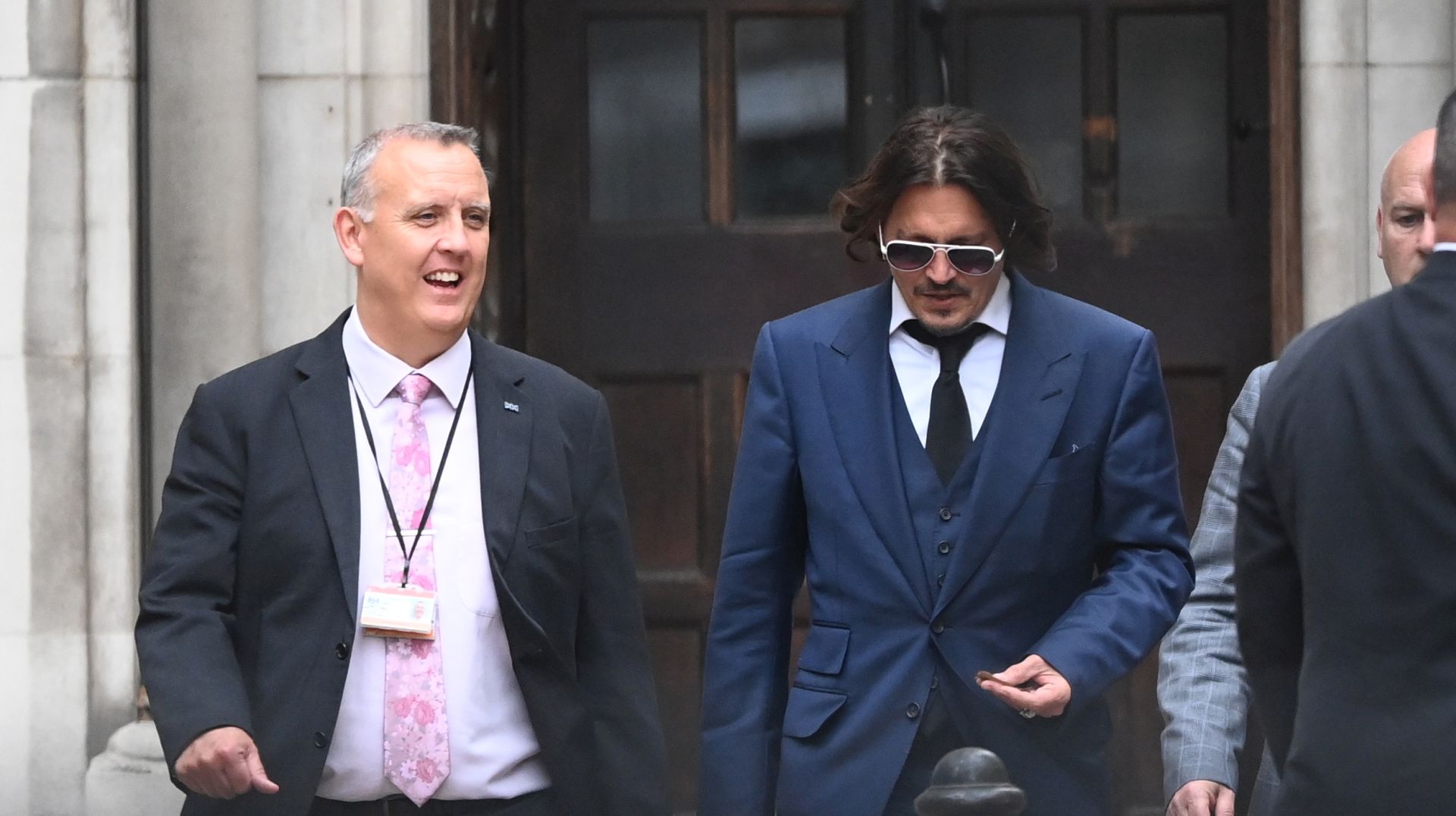 epa08532741 US actor Johnny Depp (C) leaves the Royal Courts of Justice in London, Britain, 07 July 2020. Depp is suing The Sun's newspaper publisher News Group Newspapers (NGN) over claims he abused his ex-wife, US actress Amber Heard, reports state.  EPA/FACUNDO ARRIZABALAGA