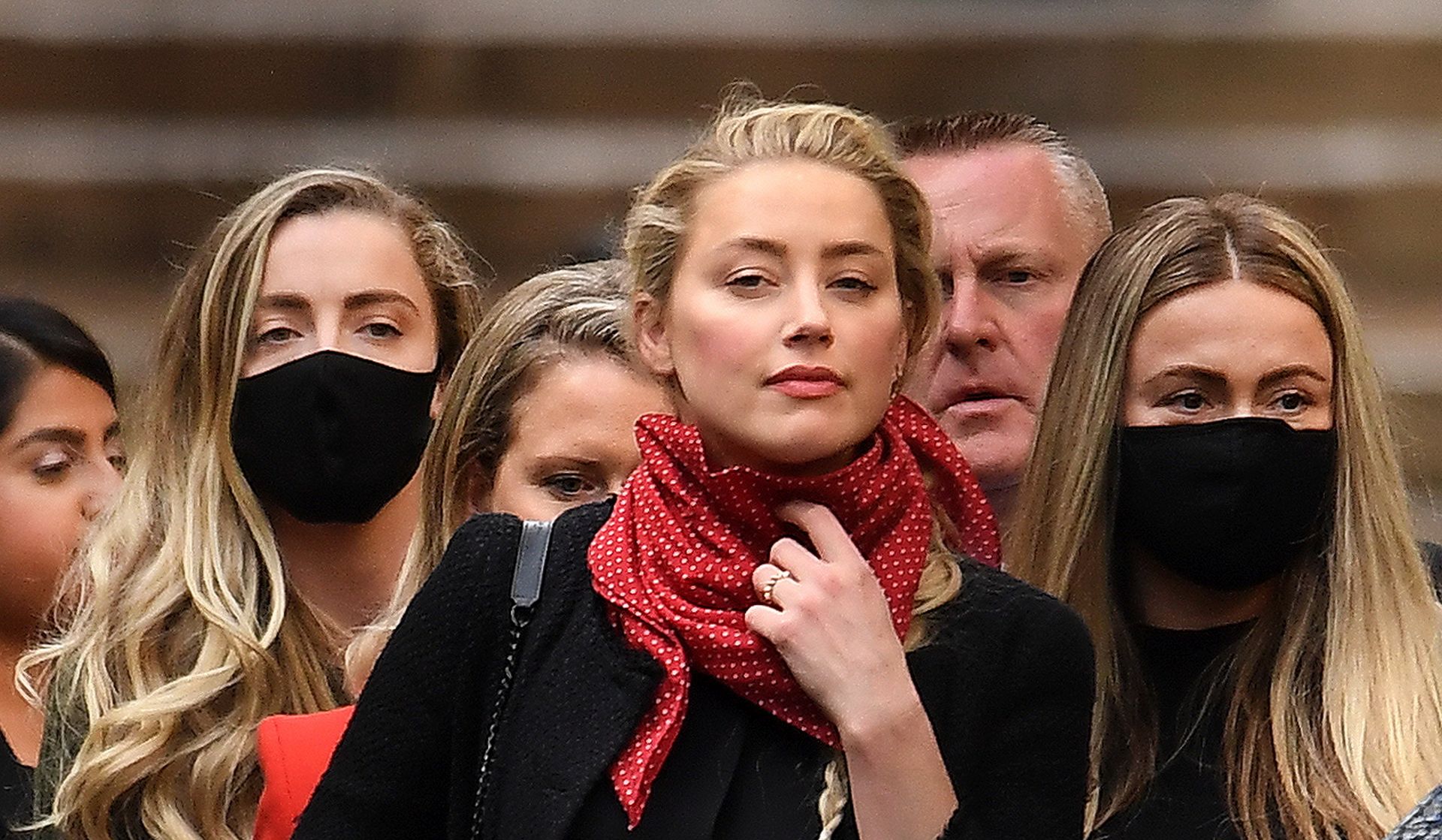 epa08543861 US actress Amber Heard (C) departs the Royal Courts of Justice with her legal team in London, Britain, 13 July 2020. Heard's ex-husband US actor Johnny Depp is suing The Sun's newspaper publisher News Group Newspapers (NGN) over claims he abused his ex-wife.  EPA/ANDY RAIN