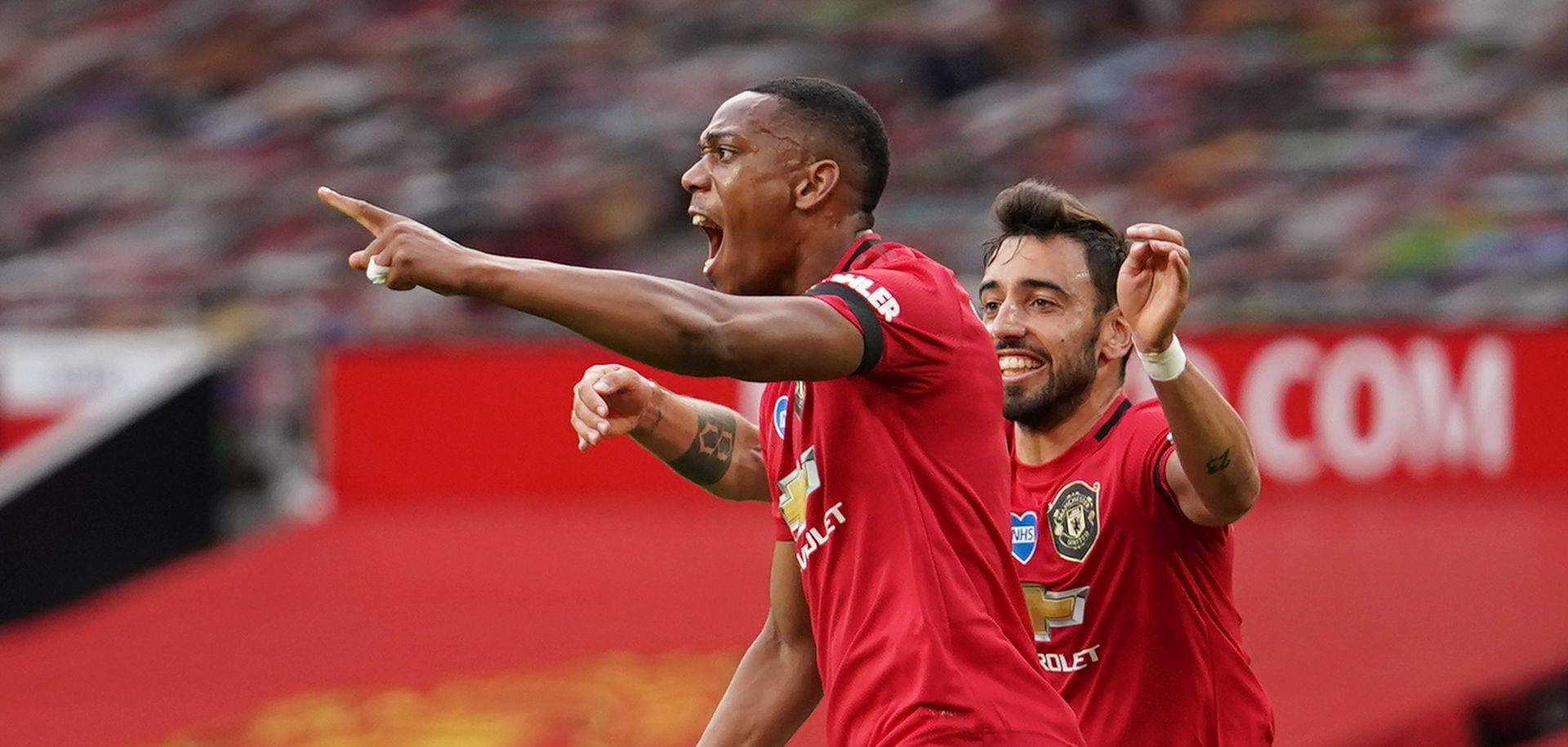 epa08544098 Anthony Martial of Manchester United (L) celebrates scoring his team's second goal  during the English Premier League match between Manchester United and Southampton FC in Manchester, Britain, 13 July 2020.  EPA/Dave Thompson/NMC/Pool EDITORIAL USE ONLY. No use with unauthorized audio, video, data, fixture lists, club/league logos or 'live' services. Online in-match use limited to 120 images, no video emulation. No use in betting, games or single club/league/player publications.