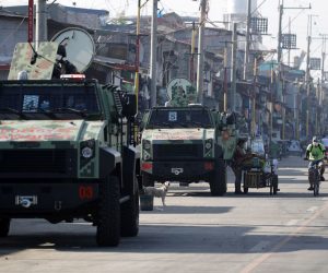 epa08548823 Filipino police officers on armored personnel carriers conduct a patrol during a lockdown in Navotas City, Philippines, 16 July 2020. According to reports, Navotas City will go back into a two week lockdown starting on 16 July, to contain the surge of coronavirus infections.  EPA/FRANCIS R. MALASIG