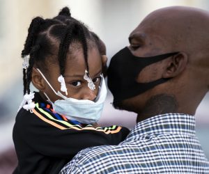 epa08552860 Father and daughter wearing face masks wait to get a COVID-19 test at the St. John's Well Child and Family Center mobile COVID-19 clinic set up outside 118th Street Elementary School amid the coronavirus pandemic in Los Angeles, California, USA, 17 July 2020. The St. John's Well Child and Family Center is organizing COVID-19 in a mobile testing units in the area, most of the residents they are currently testing in their South L.A. clinics are Latinos and Afro-Americans. The California Department of Health reported that Latinos are currently 2.9 times more likely than white people to test positive for the coronavirus.  EPA/ETIENNE LAURENT