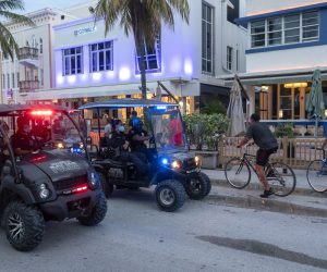 epa08554189 Miami Beach Police Department’s officers enforce the South beach 8pm-6am curfew in Miami beach, Florida, USA, 18 July 2020. The City of Miami Beach has established a new curfew in the South Beach Entertainment District to fight the spread of coronavirus. The new 8pm. curfew cafe into effect on 18 July, according to a statement from city officials.  EPA/CRISTOBAL HERRERA-ULASHKEVICH