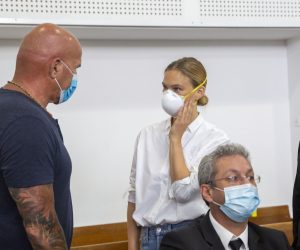 epa08556076 Israeli top model Bar Refaeli (C) wearing a face mask arrives to a court along with her father Raffi (L) and lawyers in Tel Aviv, Israel, 20 July 2020. Refaeli signed a plea bargain agreement with authorities to settle a long-standing tax evasion case against her and her family. The deal will require Refaeli to serve nine months of community service while her mother, Zipi, will be sent to prison for 16 months. The two are also ordered to pay a US dollars 1.5 million fine on top of millions of back taxes owed to the state.  EPA/Oded Balilty / POOL