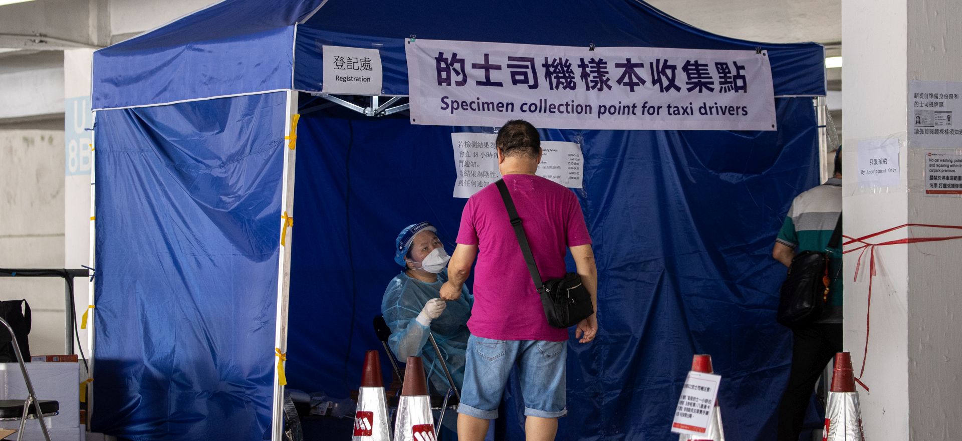 epa08561768 A taxi driver arrives at a makeshift COVID-19 testing lab in a parking lot in Hong Kong, China, 23 July 2020. The city has seen record surges in COVID-19 cases in the past couple of weeks and some health experts have suggested that Hong Kong may have to go into lockdown.  EPA/JEROME FAVRE