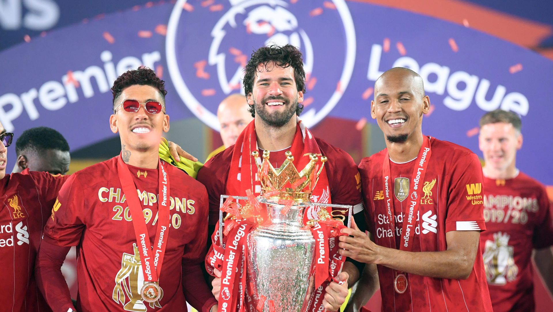 epa08562253 Liverpool's Brazilian players (L-R), Roberto Firmino, Alisson Becker and Fabinho celebrate with the trophy the Premier League 2020 title following the English Premier League soccer match between Liverpool FC and Chelsea FC in Liverpool, Britain, 22 July 2020.  EPA/Laurence Griffiths/NMC/Pool EDITORIAL USE ONLY. No use with unauthorized audio, video, data, fixture lists, club/league logos or 'live' services. Online in-match use limited to 120 images, no video emulation. No use in betting, games or single club/league/player publications.