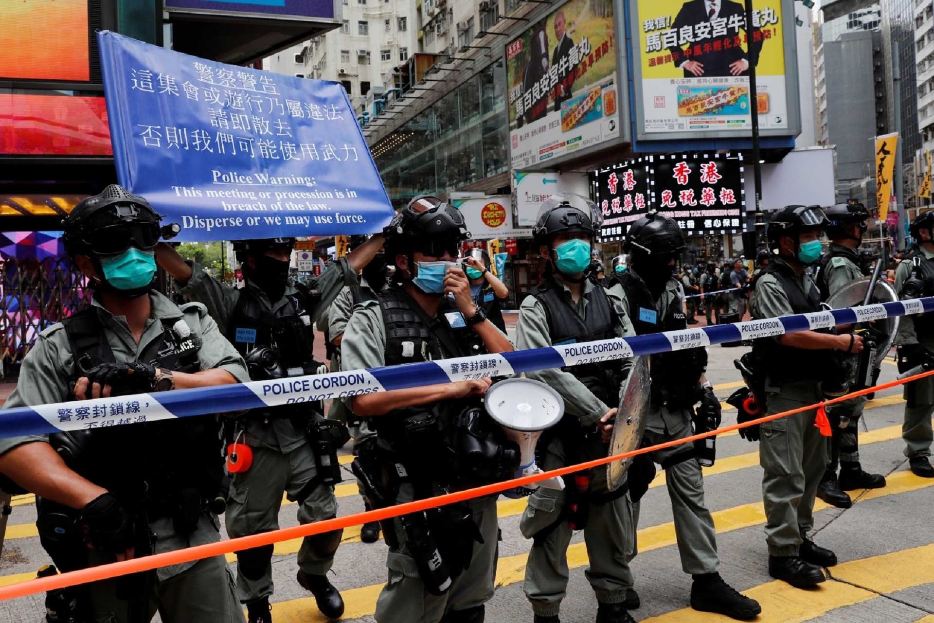 Riot police stand in line as anti-national security law protesters march at the anniversary of Hong Kong's handover to China from Britain in Hong Kong Riot police stand in line as anti-national security law protesters march at the anniversary of Hong Kong's handover to China from Britain in Hong Kong, China July 1, 2020. REUTERS/Tyrone Siu TYRONE SIU