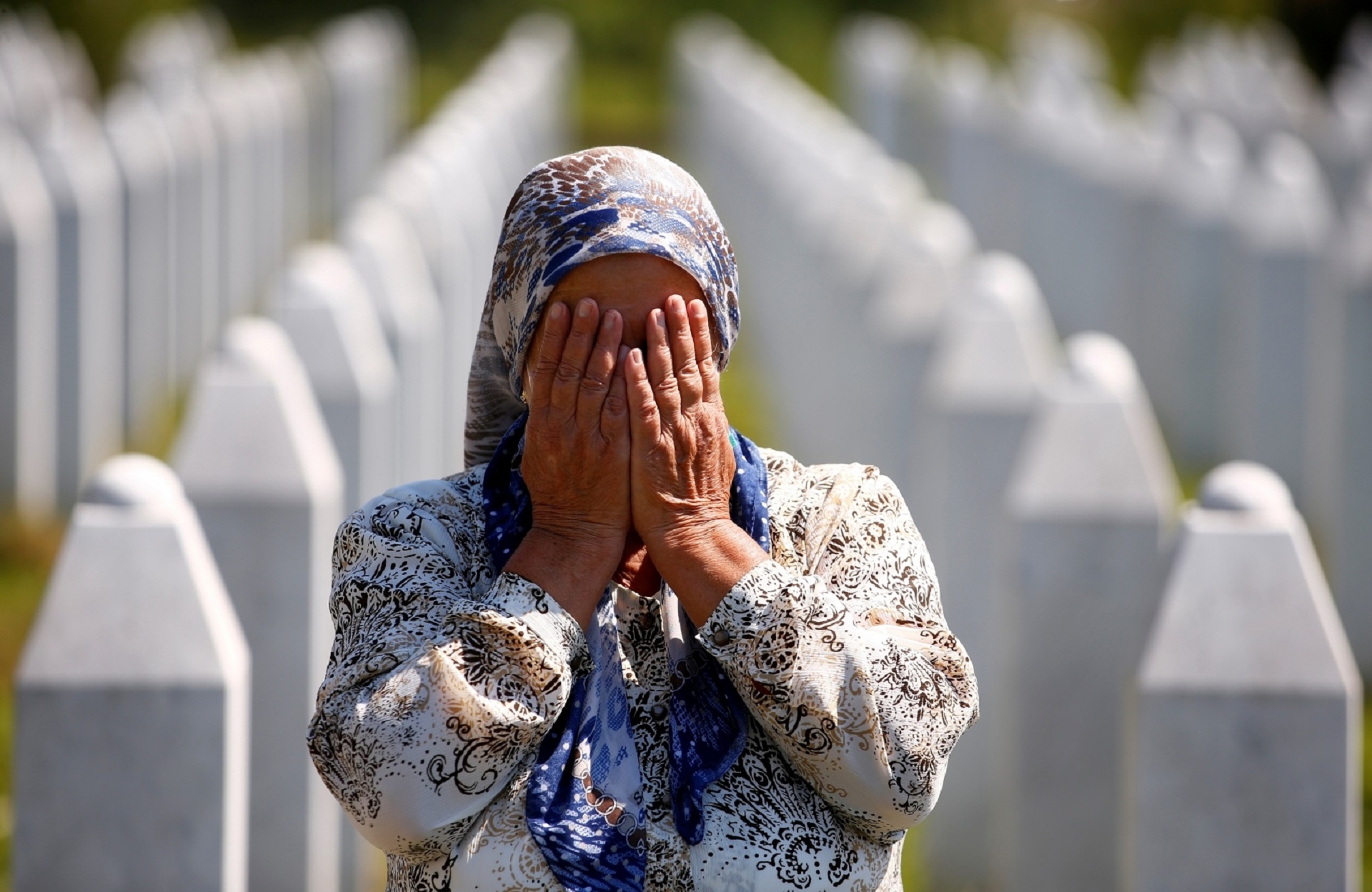 Bosnia and Herzegovina commemorates 25th anniversary of Srebrenica massacre, in Potocari A woman prays at a graveyard, ahead of a mass funeral in Potocari near Srebrenica, Bosnia and Herzegovina July 11, 2020. Bosnia marks the 25th anniversary of the massacre of more than 8,000 Bosnian Muslim men and boys, with many relatives unable to attend due to the coronavirus disease (COVID-19) outbreak. REUTERS/Dado Ruvic     TPX IMAGES OF THE DAY DADO RUVIC