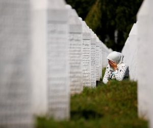 Bosnia and Herzegovina commemorates 25th anniversary of Srebrenica massacre, in Potocari A woman cries at a graveyard, ahead of a mass funeral in Potocari near Srebrenica, Bosnia and Herzegovina July 11, 2020. Bosnia marks the 25th anniversary of the massacre of more than 8,000 Bosnian Muslim men and boys, with many relatives unable to attend due to the coronavirus disease (COVID-19) outbreak. REUTERS/Dado Ruvic     TPX IMAGES OF THE DAY DADO RUVIC