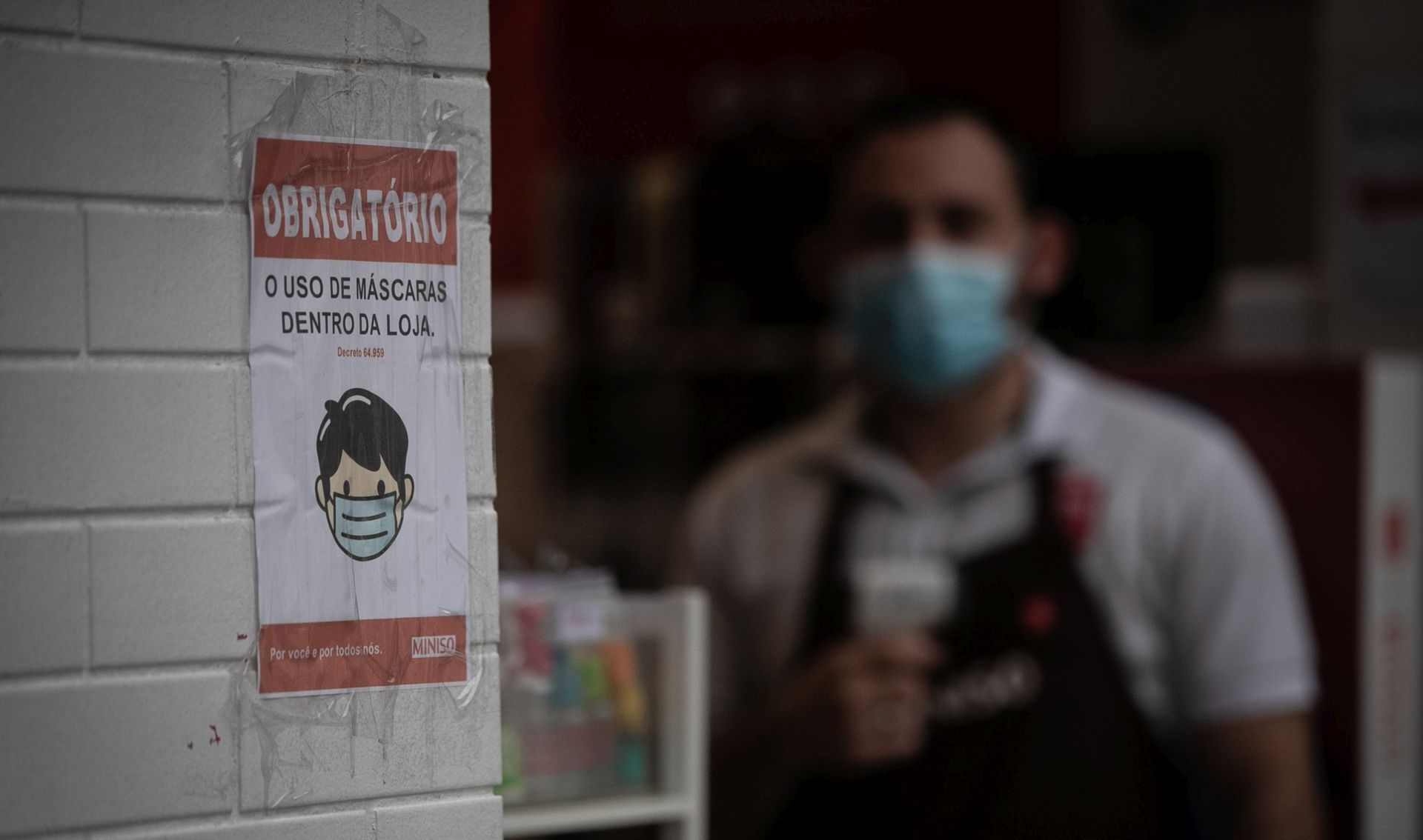 epa08550226 Detail of the sign with an indication of mandatory use of face masks inside a store, in Sao Paulo, Brazil, 16 July 2020.  EPA/Fernando Bizerra