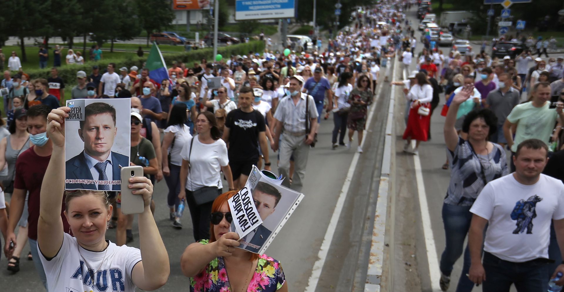 epa08565963 A woman holds a portrait of arrested governor of the Khabarovsk region Sergei Furgal, during a rally in his support in Khabarovsk, Russia, 25 July 2020. Sergei Furgal was arrested on 09 July 2020 suspected in organizing several contract killings of businessmen, his business partners in 2004-2005.  EPA/ALEKSANDR KOLBIN