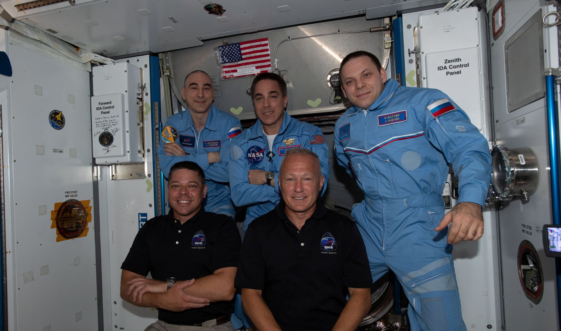 epa08568646 A handout picture made available by the National Aeronautics and Space Administration (NASA) shows newly-expanded Expedition 63 crew with NASA astronauts (front row, from L) Bob Behnken and Doug Hurley having just entered the International Space Station (ISS) shortly after arriving aboard the SpaceX Crew Dragon spacecraft, 31 May 2020 (issued 27 July 2020). In picture are NASA Commander Chris Cassidy (C, back row), flanked by Roscosmos Flight Engineers Anatoly Ivanishin (L) and Ivan Vagner (R). After two months aboard the International Space Station, astronauts Bob Behnken and Doug Hurley are planned to return home. The duo will undock with the SpaceX's Crew Dragon spacecraft from the ISS sometime on 01 August and then splashdown in the Atlantic Ocean on 02 August ending NASA's first crewed mission aboard a commercial spacecraft.  EPA/NASA HANDOUT  HANDOUT EDITORIAL USE ONLY/NO SALES