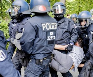 01 August 2020, Berlin: Policemen arrest a protester as they break up a demonstration organized by the 'Querdenken 711' group, against the restrictive measures imposed by the government to curb the spreading of coronavirus. Photo: Christoph Soeder/dpa