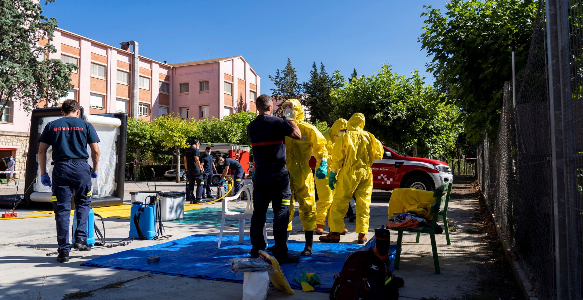 epa08583027 Local firefighters disinfect a care home in Burbaguena, Teruel, Spain, 04 August 2020. A Coronavirus outbreak has been detected in a care home in Burbaguena.  EPA/Antonio Garcia
