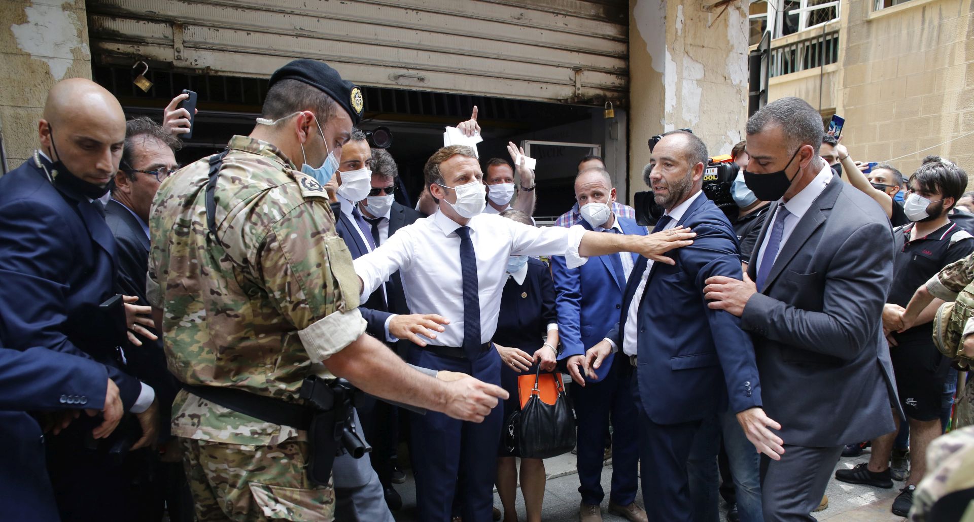 epa08587266 French President Emmanuel Macron gestures as he visits a devastated street of Beirut, Lebanon, 06 August 2020. Macron arrived to Lebanon to show support after a massive explosion on 04 August in which at least 135 people were killed, and more than 5,000 injured in what believed to have been caused by an estimated 2,750 of ammonium nitrate stored in a warehouse.  EPA/Thibault Camus / POOL MAXPPP OUT