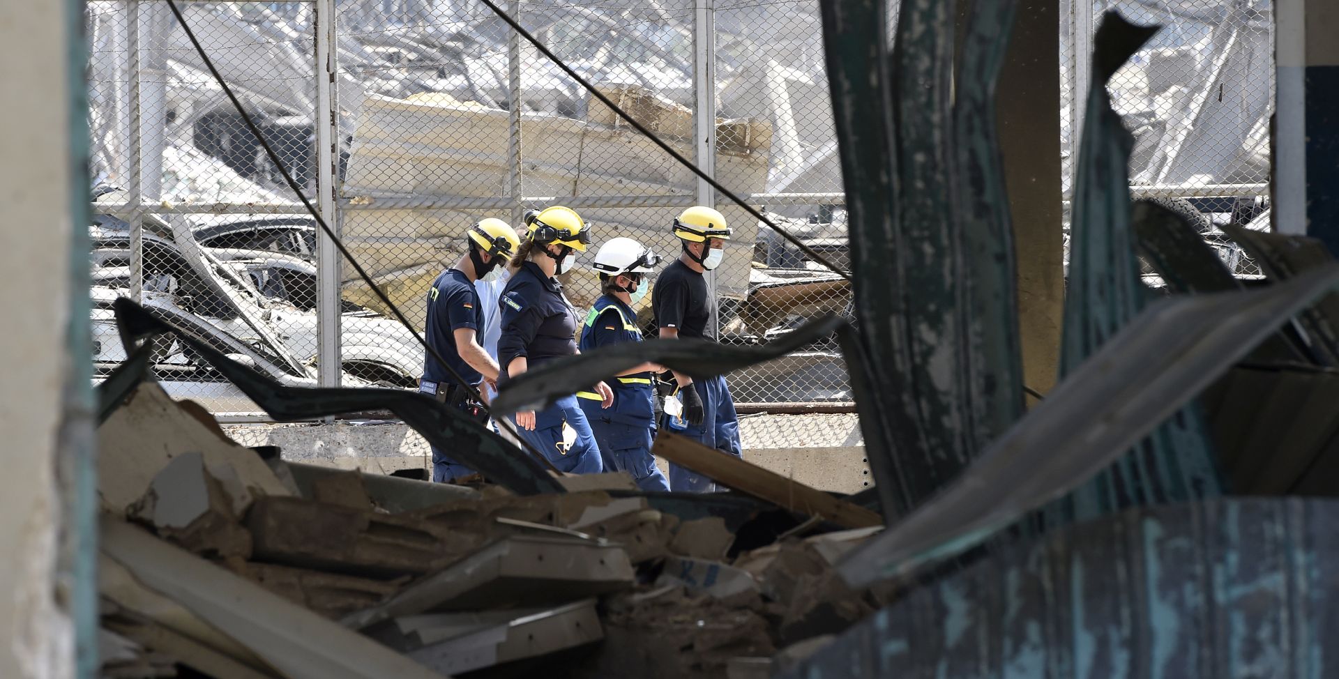epa08589337 Members of German Federal Agency for Technical Relief (THW) search for bodies and survivors amid the rubble three days after explosions that hit Beirut port, in Beirut, Lebanon, 07 August 2020. According to the Lebanese Health Ministry, at least 137 people were killed, and more than 5,000 injured in the blast believed to have been caused by an estimated 2,750 tons of ammonium nitrate stored in a warehouse. The explosion and its shockwave on 04 August 2020 devastated the port area.  EPA/WAEL HAMZEH