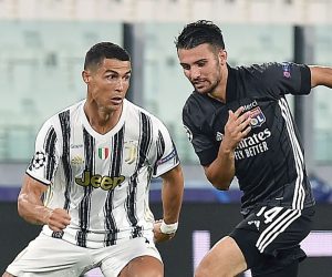 epa08590597 Juventus’ Cristiano Ronaldo and Lyon’s Leo Dubois in action during the UEFA Champions League round of 16 second leg soccer match Juventus FC vs Olympique Lyon at the Allianz Stadium in Turin, Italy, 07 August 2020.  EPA/ALESSANDRO DI MARCO