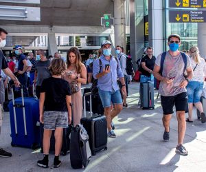 epa08593850 Tourists arrive at the Son Sant Joan airport in Palma de Mallorca, Balearic Islands, Spain, 09 August 2020. Over 270 flights are expected to land and other 270 expected to take off during the day.  EPA/CATI CLADERA