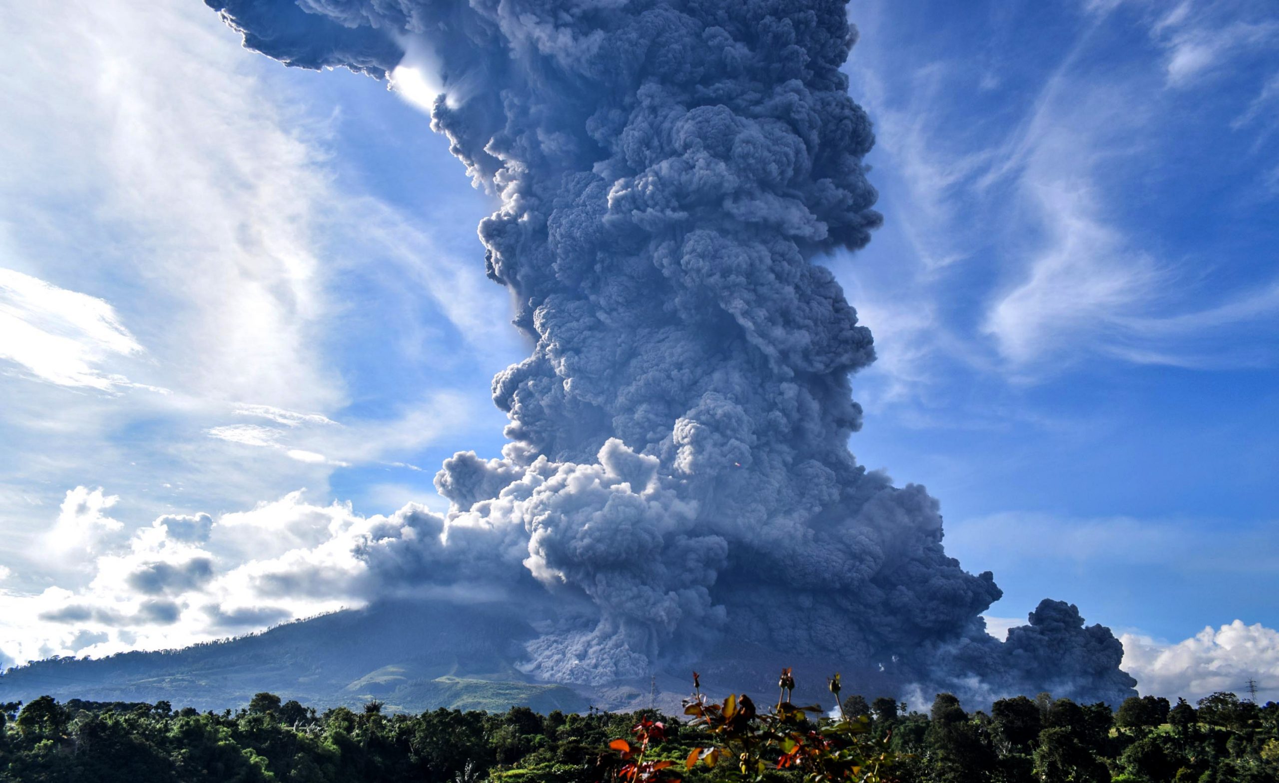 epa08594601 (FILE) - Mount Sinabung spews volcanic smoke in Tiga Pancur Village, Karo, North Sumatra, Indonesia, 09 June 2019 (reissued 10 August 2020). According to latest media reports, Mount Sinabung, one of the most active volcanoes in Indonesia, erupted on 10 August spewing a column of volcanic ash high into the sky. Indonesia sits on the Pacific Ring of Fire, which accounts for 80 percent of the world's seismic activity.  EPA/SARIANTO SEMBIRING