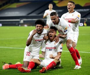 epa08598150 Sevilla's Lucas Ocampos (C, bottom) celebrates with his teammates after scoring the 1-0 lead during the UEFA Europa League quarter final soccer match between Wolverhampton Wanderers and Sevilla FC in Duisburg, Germany 11 August 2020.  EPA/Friedemann Vogel / POOL