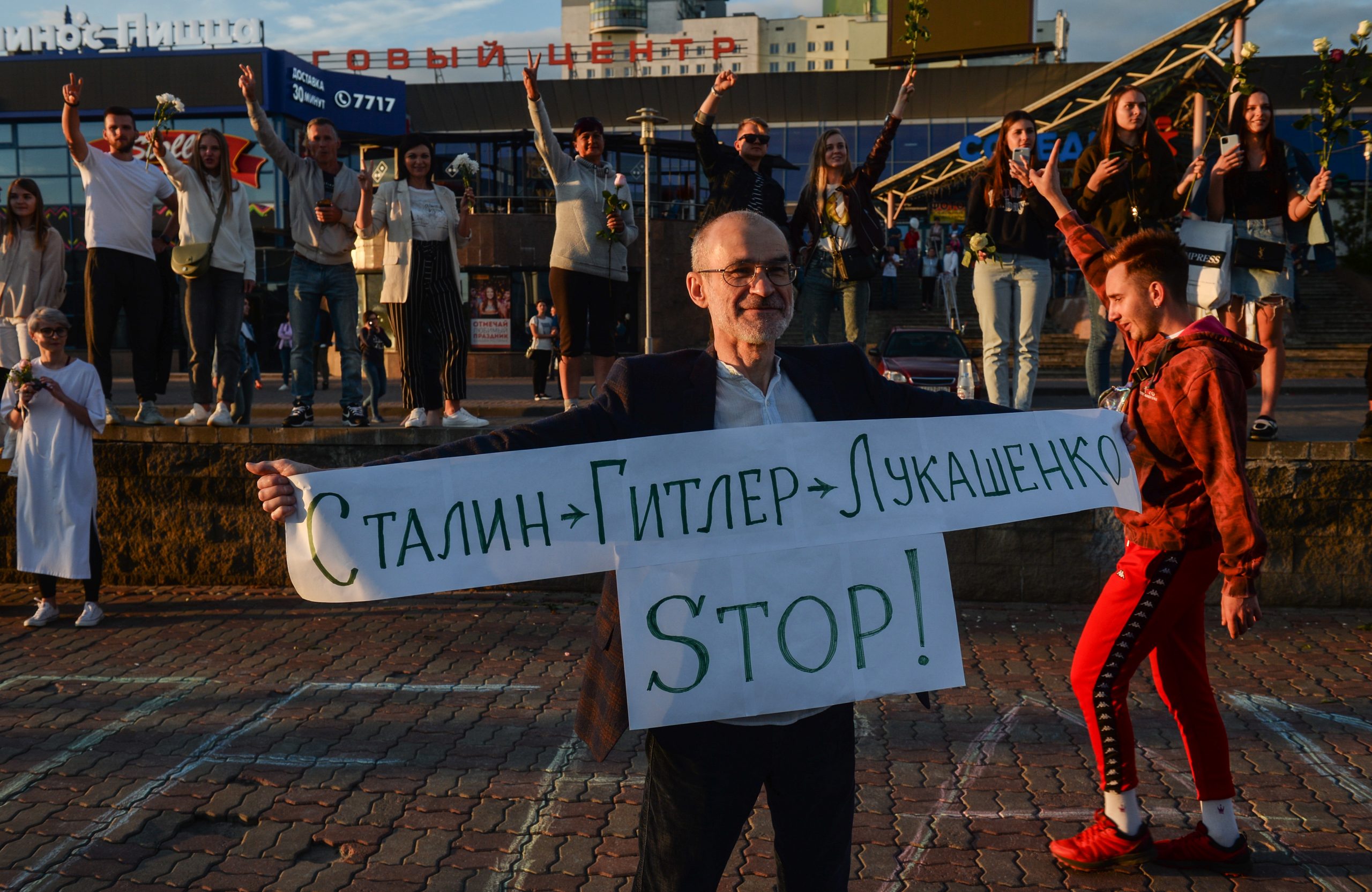 epa08601590 A man holds poster signed 'Stalin - Hitler - Lukashenko - STOP!' during a rally in support of detained and injured participants of the protests that erupted in the aftermath of the presidential election, in Minsk, Belarus, 13  August 2020. Long-time President of Belarus Alexander Lukashenko won the elections by a landslide with 80 percent of the votes, a result questioned and protested by the oppositions. Opposition leader Tikhanovskaya fled to Lithuania after rejecting the election results she claimed was rigged.  EPA/YAUHEN YERCHAK