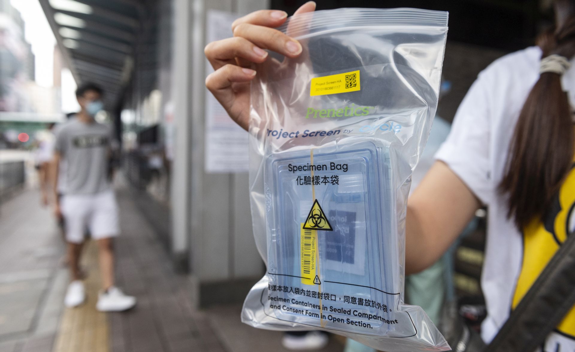epa08613956 A resident shows a free COVID-19 test kit distributed by the government at the Cheung Sha Wan Government Offices building in Sham Shui Po, Hong Kong, China, 20 August 2020. Hong Kong is expected to launch a citywide voluntary COVID-19 testing program on 01 September 2020 to combat a new wave of coronavirus infection.  EPA/MIGUEL CANDELA