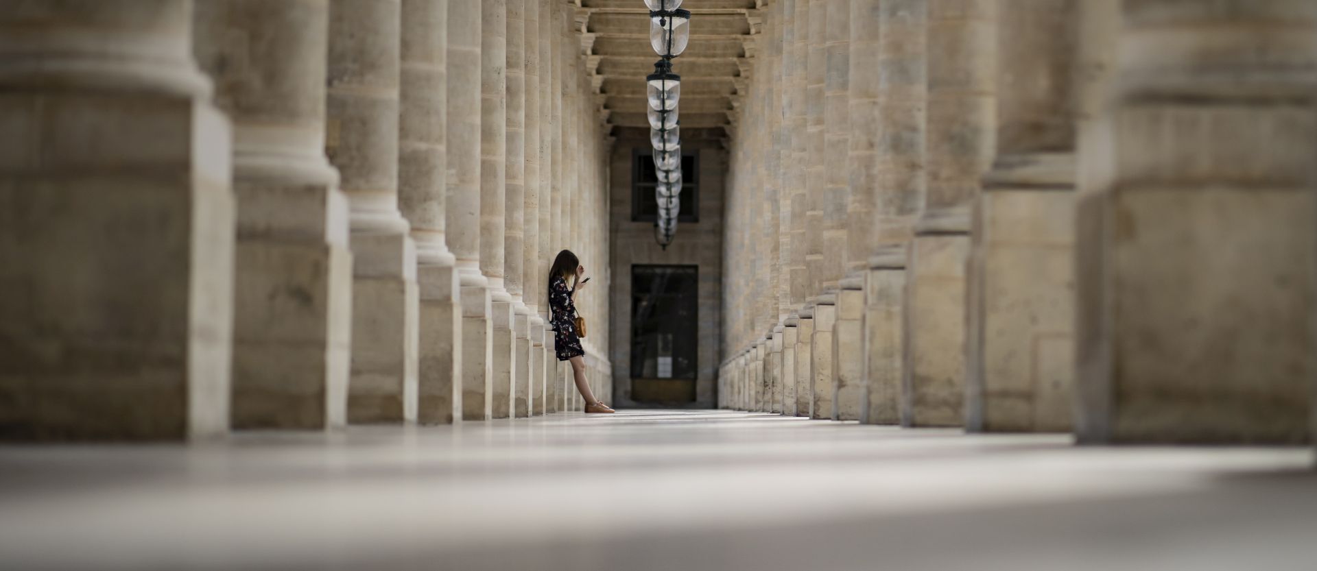 epa08614392 A woman pauses in an arcade of the Palais Royal in Paris, France, 20 August 2020. Paris has been declared a zone of 'active circulation' for the Covid19 coronavirus as cases surged in recent weeks, prompting British tourists vacationing in France to be recalled back to their homeland or face fourteen days quarantine upon arrival. The spike in Covid cases and foreign tourist exodus is affecting Paris' tourism industry, with media reports of hotel reservations down by 86 per cent comparatively to last year.  EPA/IAN LANGSDON