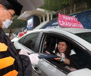 epaselect epa08615786 A graduating senior in a car receives a diploma from Hongik University in Seoul, South korea, 21 August 2020. The school held an outdoor drive-in graduation ceremony amid rising cases of COVID-19 in the country.  EPA/YONHAP SOUTH KOREA OUT