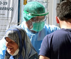 epa08616212 A medical staff attends to a people as she arrives to test for coronavirus, at a hospital in Sarajevo, Bosnia and Herzegovina, 21 August 2020. Countries around the world are taking increased measures to stem the widespread of the SARS-CoV-2 coronavirus which causes the Covid-19 disease.  EPA/FEHIM DEMIR