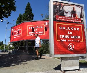 epa08629361 A man walks past a row of campaign billboards of the ruling Democratic Party of Socialists (DPS) of incumbent President Milo Djukanovic ahead of the upcoming parliamentary elections, in Podgorica, Montenegro, 27 August 2020. Parliamentary elections are due to be held in Montenegro on 30 August 2020.  EPA/BORIS PEJOVIC