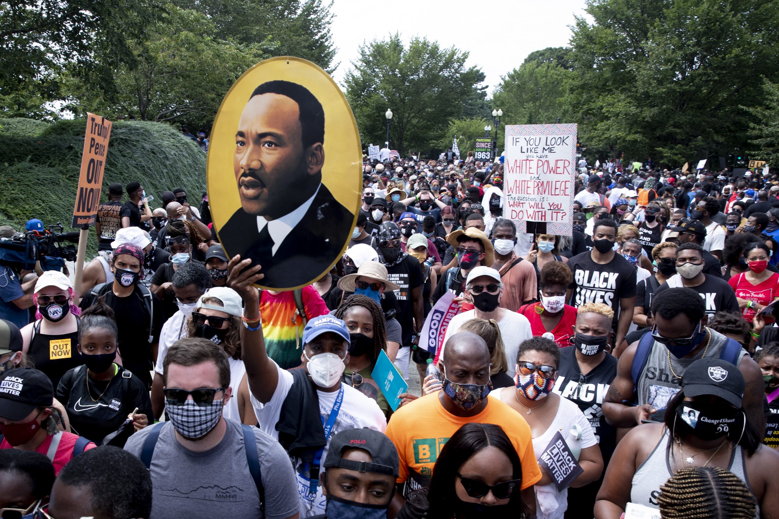 epa08632791 The image of Martin Luther King Jr. is seen among the crowd marching from the Lincoln Memorial to the Martin Luther King Jr. Memorial during the 'Commitment March: Get Your Knee Off Our Necks', in Washington, DC, USA, 28 August 2020. The March on Washington comes on the 57th anniversary of Dr. Martin Luther King's historic march, when he delivered his 'I Have a Dream' speech.  EPA/MICHAEL REYNOLDS