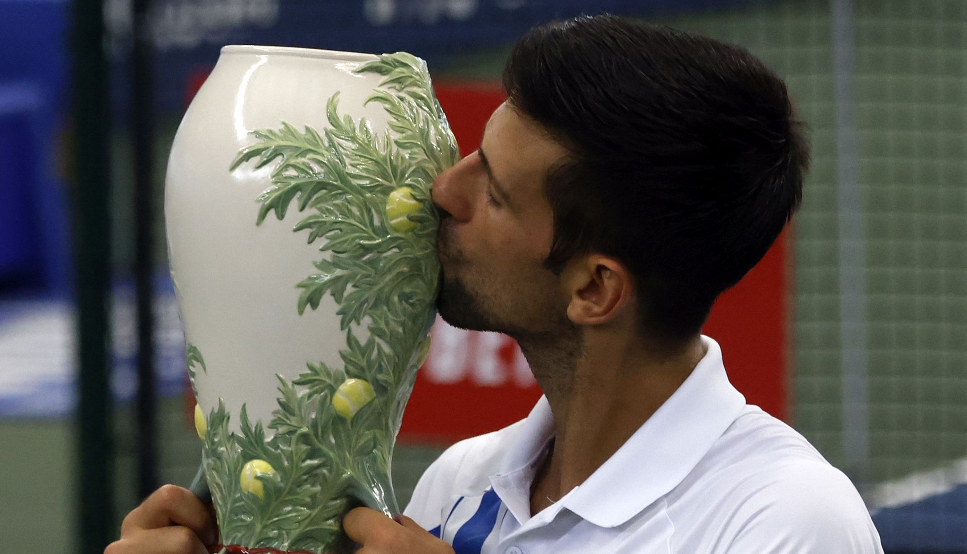 epa08634598 Novak Djokovic of Serbia kisses the Rookwood Cup trophy after defeating Milos Raonic of Canada during their Men's finals match at the Western and Southern Open at the USTA National Tennis Center in Flushing Meadows, New York, USA, 29 August 2020.  EPA/JASON SZENES