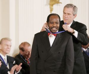 epa08637332 (FILE) - US President George W. Bush awards the Presidential Medal of Freedom to Rwandan hotelier Paul Rusesabagina, who protected people at a hotel he managed during the 1994 Rwandan genocide, during a ceremony in the East Room of the White House in Washington, DC, USA, 09 November 2005 (reissued 31 August 2020). Rwandan authorities on 31 August 2020 said that Rusesabagina was arrested on terror related offenses in Kigali.  The Rwanda Investigation Buerau (RIB) in a statement announced he was "subject of an International Arrest Warrant, wanted to answer charges of serious crime including terrorism, arson, kidnap and murder".  EPA/SHAWN THEW *** Local Caption *** 00571061