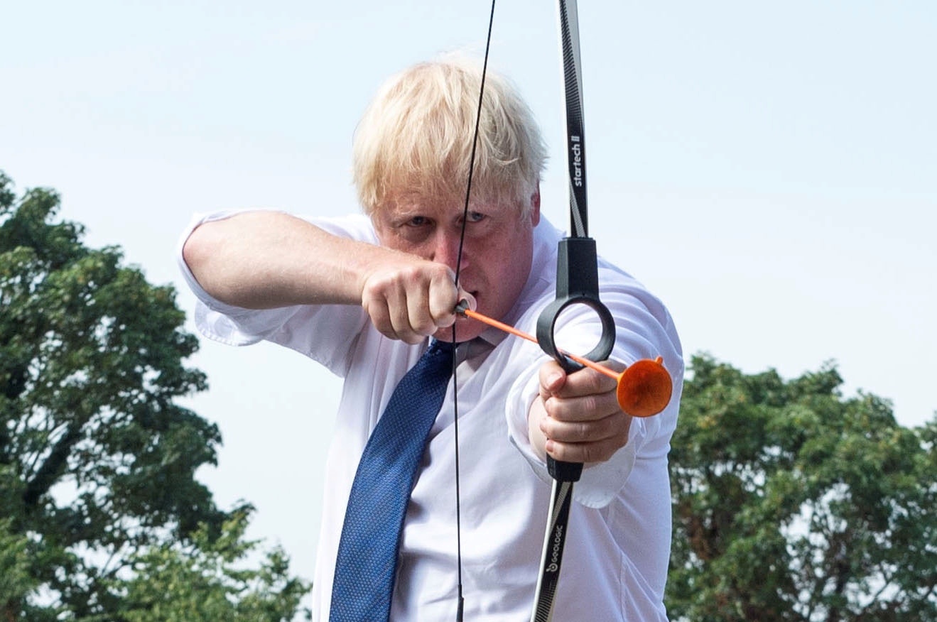 Britain's PM Johnson visits Premier Education Summer Camp at Sacred Heart of Mary Girls' in Upminster Britain's Prime Minister Boris Johnson takes part in an archery session as he visits Premier Education Summer Camp at Sacred Heart of Mary Girls', as the coronavirus disease (COVID-19) outbreak continues, in Upminster, London, Britain August 10, 2020. Lucy Young/Pool via REUTERS     TPX IMAGES OF THE DAY POOL