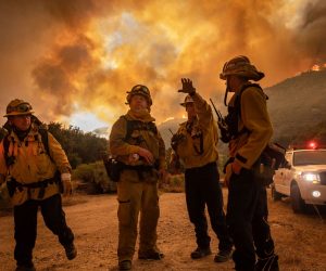 epaselect epa08600280 Firefighters make an escape plan as the Lake Fire burns a hillside in Lake Hughes, California, USA, 12 August 2020.  EPA/CHRISTIAN MONTERROSA