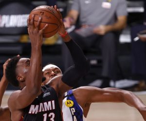 epa08619168 Miami Heat forward Bam Adebayo (L) goes to the basket as Indiana Pacers center Myles Turner (R) defends during the first half of the NBA basketball first-round playoff game three at the ESPN Wide World of Sports Complex in Kissimmee, Florida, USA, 22 August 2020.  EPA/JOHN G. MABANGLO SHUTTERSTOCK OUT