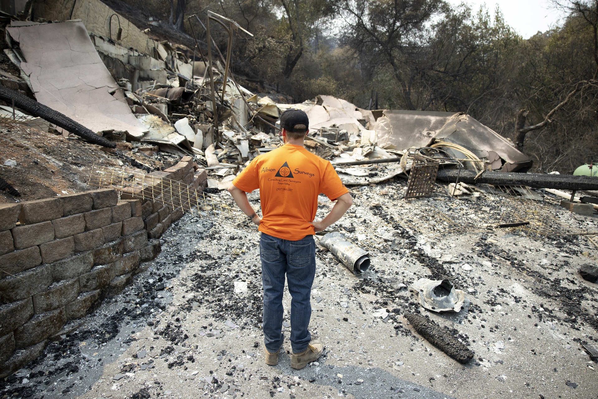 epa08623655 Gary Pratt inspects the ruins of his home at Spanish Flats Mobile Villa Park, after the LNU Lightning Complex fires past through, near Lake Berryessa, California, USA, 24 August 2020. The LNU Lightning Complex fires have burnt more than 350,000 acres across five counties.  EPA/PETER DASILVA
