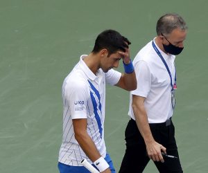 epa08651673 Novak Djokovic of Serbia (L) as walks off the court with the Head of Officiating at International Tennis Federation (ITF) Soeren Friemel after he accidentally hit a linesperson with a ball in the throat during his match against Pablo Carreno Busta of Spain on the seventh day of the US Open Tennis Championships at the USTA National Tennis Center in Flushing Meadows, New York, USA, 06 September 2020. Djokovic was defaulted from tournament. Due to the coronavirus pandemic, the US Open is being played without fans and runs from 31 August through 13 September.  EPA/JASON SZENES