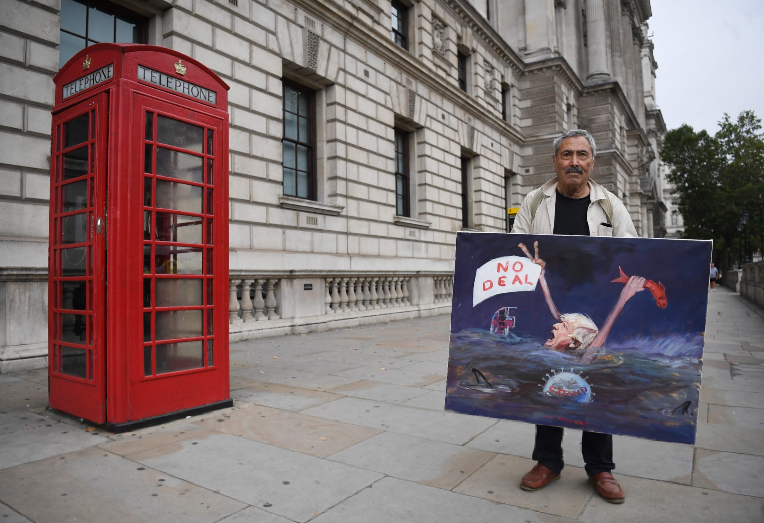 epa08656785 British satirical artist Kaya Mar poses with a painting in Westminster for the next round of Brexit talks in London, Britain, 09 September 2020. British and EU negotiators are holding talks this week to try thrash out a Brexit deal before a looming October deadline.  EPA/NEIL HALL