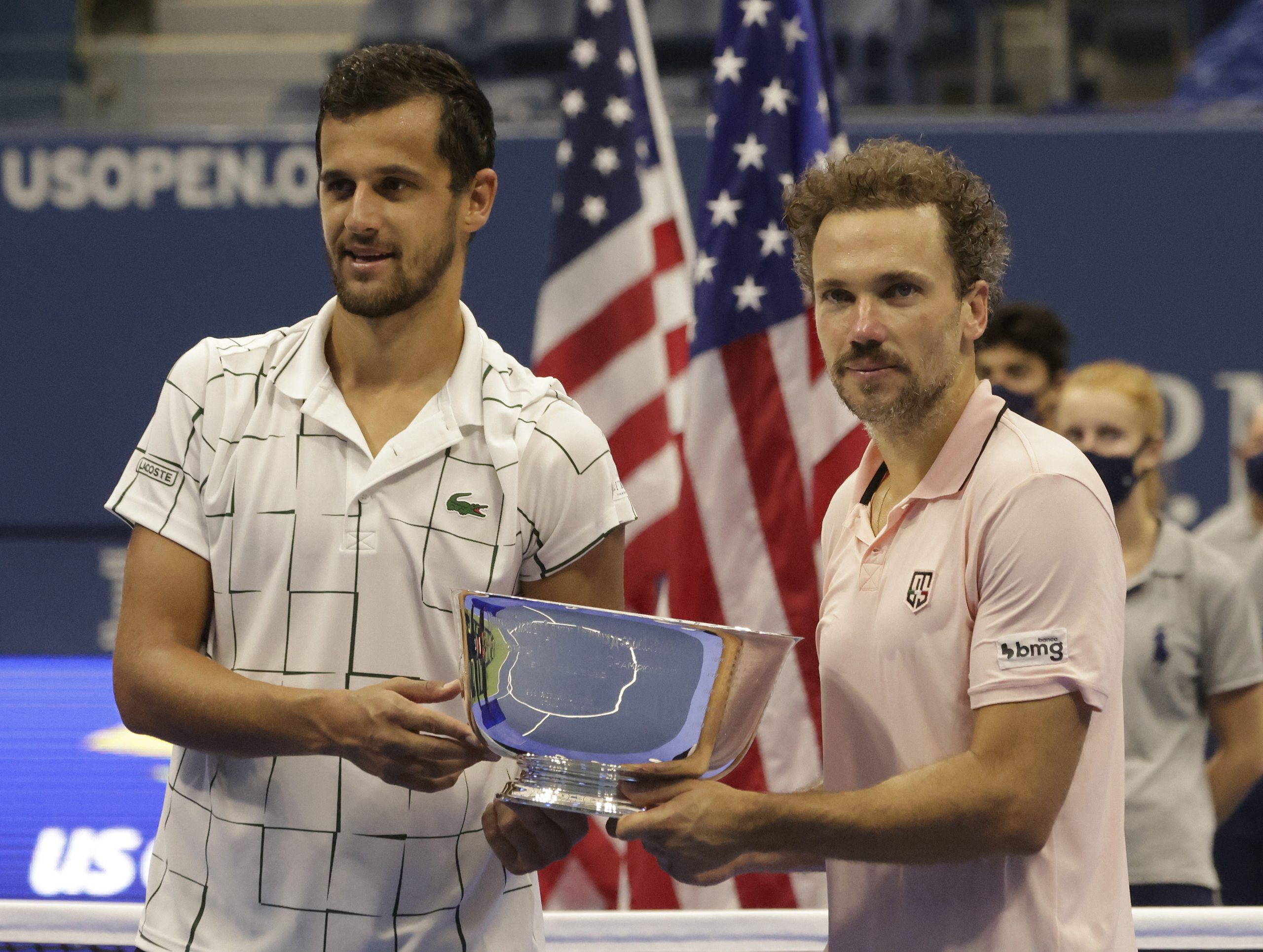 epa08660063 Mate Pavic of Croatia (L) and Bruno Soares of Brazil (R) celebrate with the Championship Trophy after defeating Wesley Koolhof of the Netherlands and Nikola Mektic of Croatia in the men's doubles final match on the eleventh day of the US Open Tennis Championships the USTA National Tennis Center in Flushing Meadows, New York, USA, 10 September 2020. Due to the coronavirus pandemic, the US Open is being played without fans and runs from 31 August through 13 September.  EPA/JASON SZENES