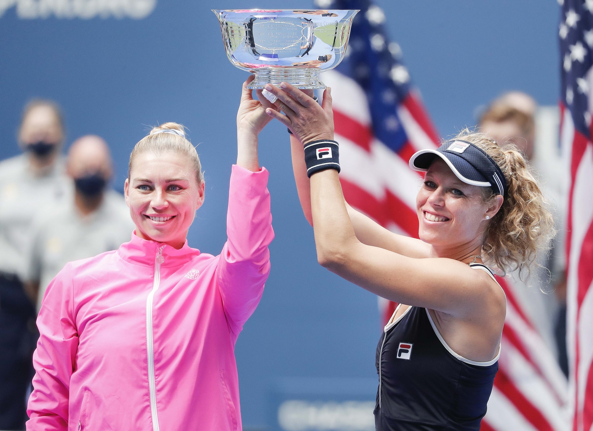 epa08662305 Teammates Vera Zvonareva (L) of Russia and Laura Siegemund of Germany hold their trophy after defeating Nicole Melichar of the US and Yifan Xu of China in the women's doubles final match on the twelfth day of the US Open Tennis Championships the USTA National Tennis Center in Flushing Meadows, New York, USA, 11 September 2020. Due to the coronavirus pandemic, the US Open is being played without fans and runs from 31 August through 13 September.  EPA/JUSTIN LANE