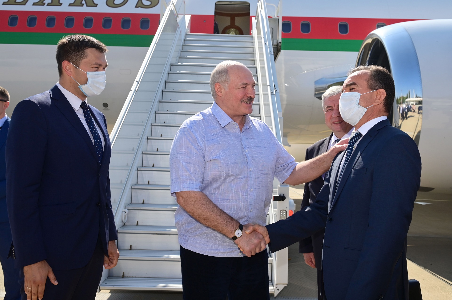epa08668278 Belarusian President Alexander Lukashenko (C) is welcomed by officials as he disembarks from a government plane upon his arrival at the Black Sea resort of Sochi, Russia, 14 September 2020. Lukashenko is in Sochi for the first fcae-to-face talks with Russian President Putin since Lukashenko's contested 09 August re-election and the subsequent and growing opposition protests.  EPA/ANDREI STASEVICH / BELTA POOL / POOL MANDATORY CREDIT