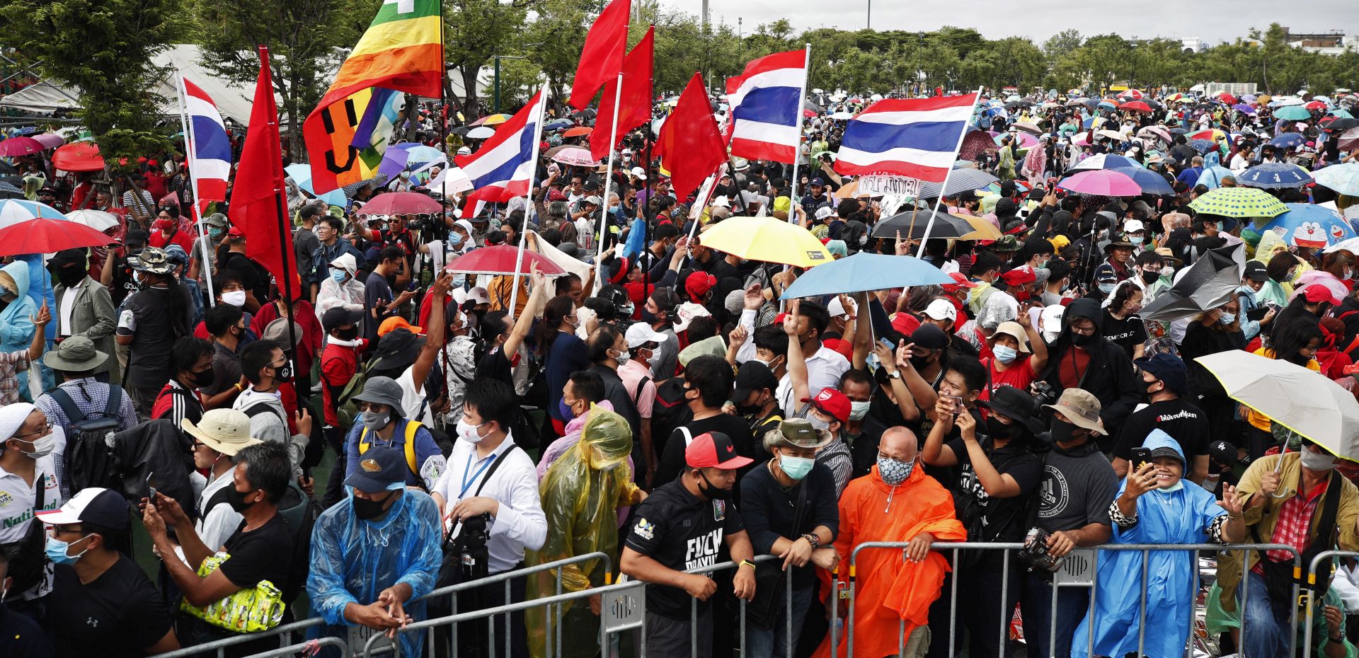epa08680264 Pro-democracy protesters wave flags during an anti-government protest at the Royal Ground of Sanam Luang in Bangkok, Thailand, 19 September 2020. Tens of thousands of anti-government protesters led by students were taking part in a mass rally against the royalist elite and the military-backed government calling for political and monarchy reforms.  EPA/RUNGROJ YONGRIT