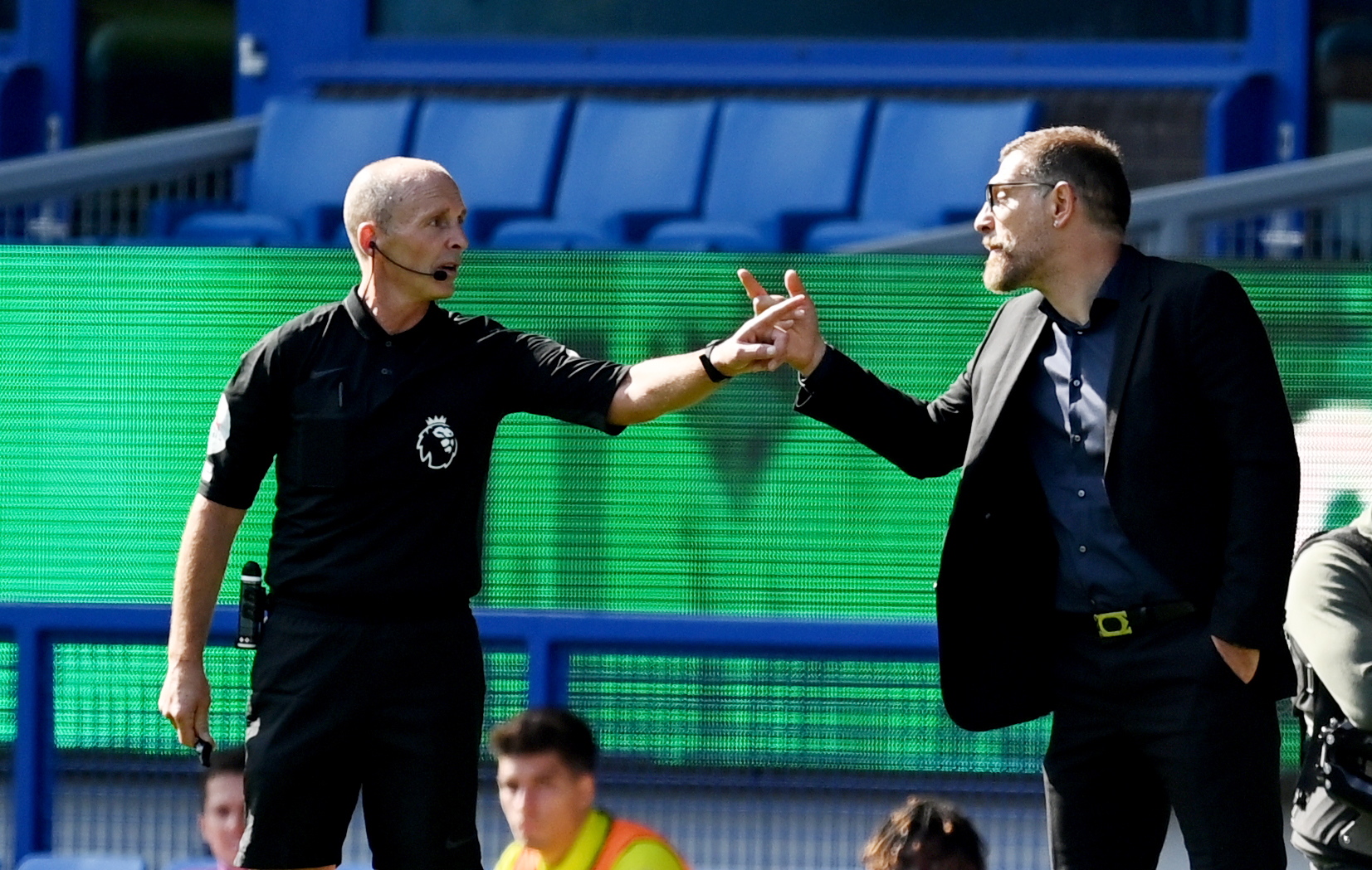 epa08680739 West Bromwich Albion's manager Slaven Bilic (R) speaks with referee Mike Dean during the English Premier League match between Everton and West Bromwich Albion in Liverpool, Britain, 19 September 2020.  EPA/Michael Regan / POOL EDITORIAL USE ONLY. No use with unauthorized audio, video, data, fixture lists, club/league logos or 'live' services. Online in-match use limited to 120 images, no video emulation. No use in betting, games or single club/league/player publications.